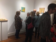 Artist discussing artwork with gallery patrons