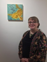 Elizabeth M. Willey, with her painting "The Oracle", which is encaustic mixed media on panel.