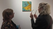 The artist discusses 'The Oracle' painting with Kathryn Nahorski, Director of the St. Louis Artists' Guild